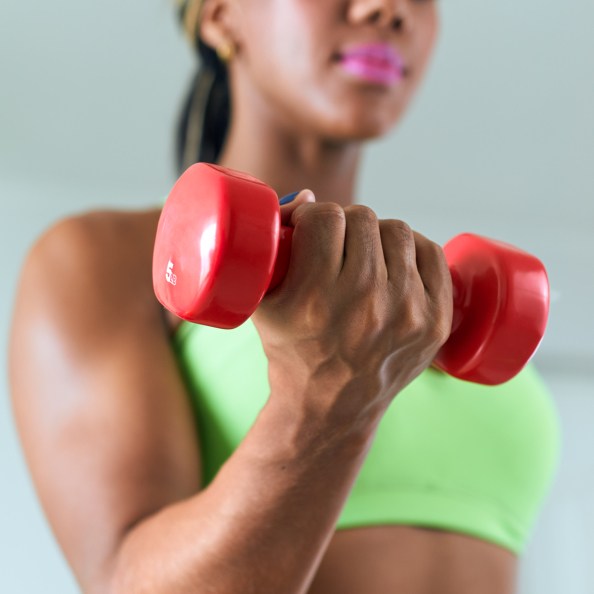 African American woman lifting dumbbell weight